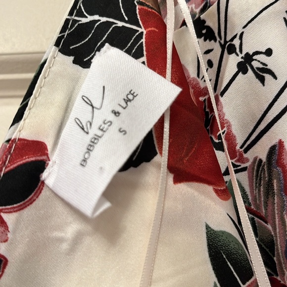 NWOT! Gorgeous silky asymmetrical dress. Has a draped scoop back. - Picture 9 of 11